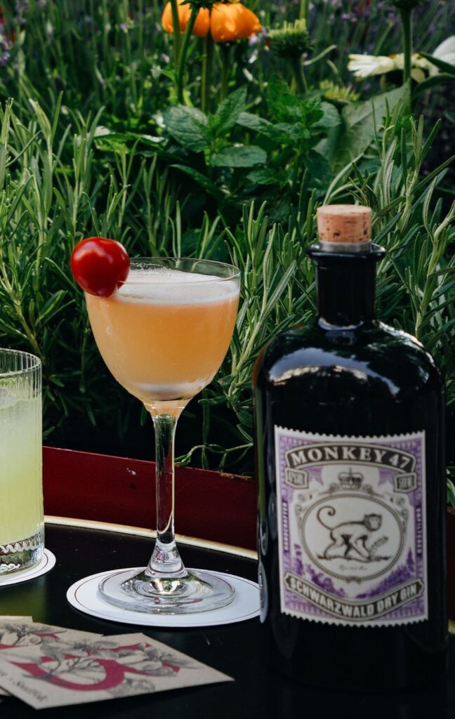 Image of cocktail in tall glass with tomato garnish